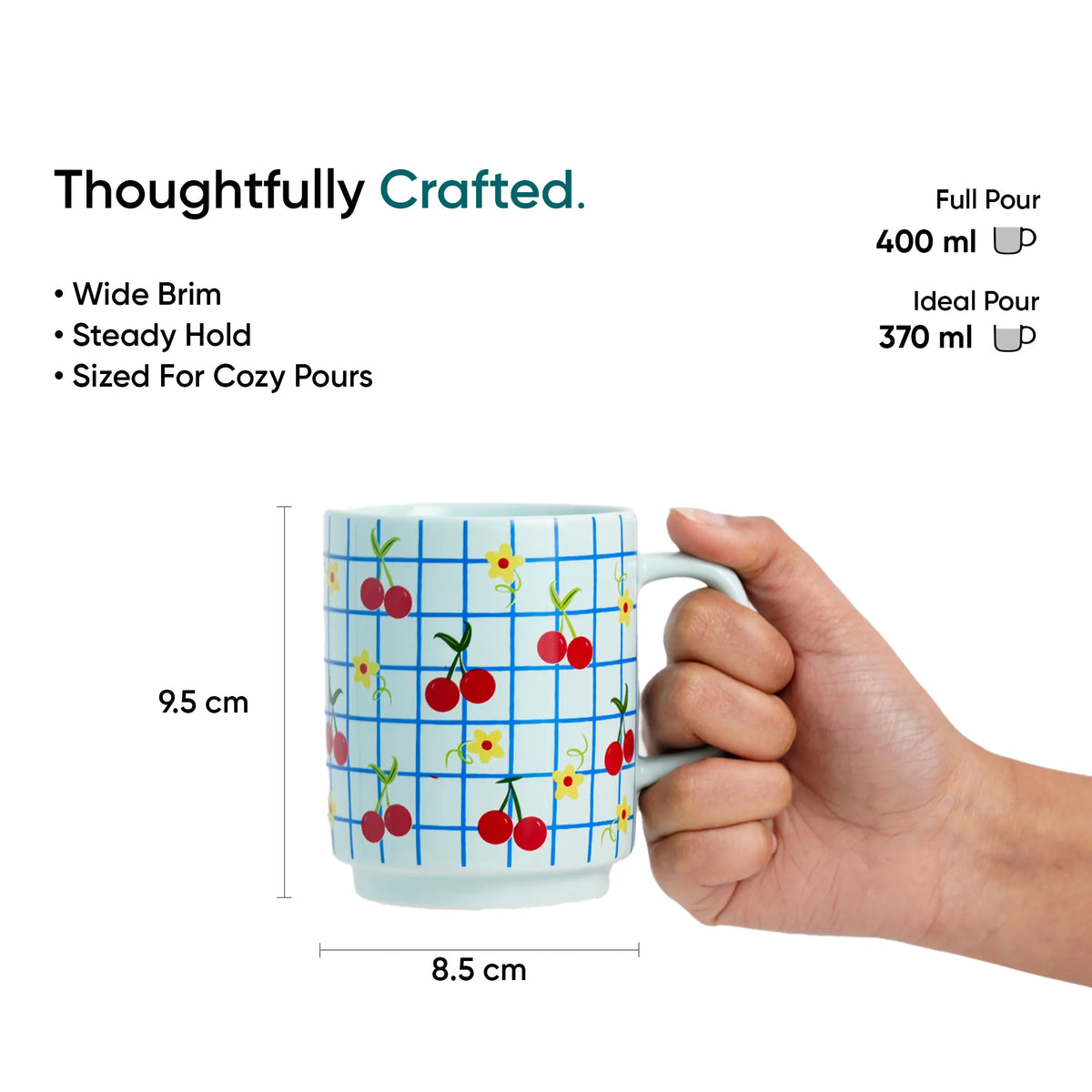 Mug with cherry design held by a hand, labeled 'Thoughtfully Crafted' with measurements and pouring details.