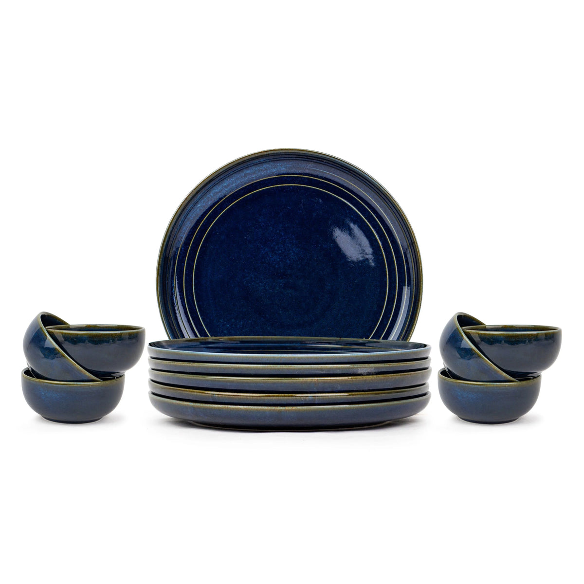 Set of blue ceramic dinnerware including plates and bowls on a white background
