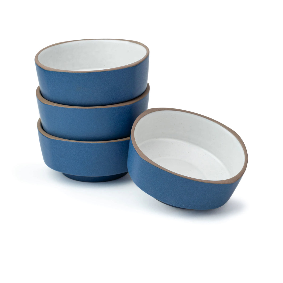 Set of blue ceramic bowls with white interiors on a white background