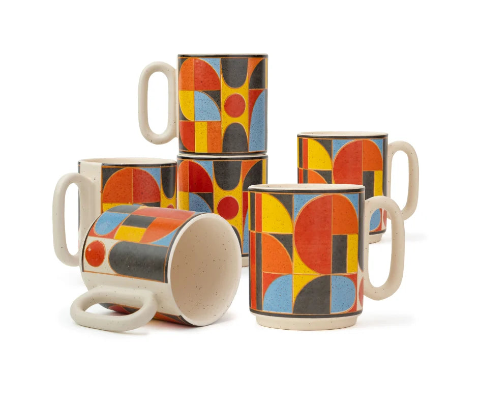 Set of ceramic mugs with abstract geometric pattern on a white background