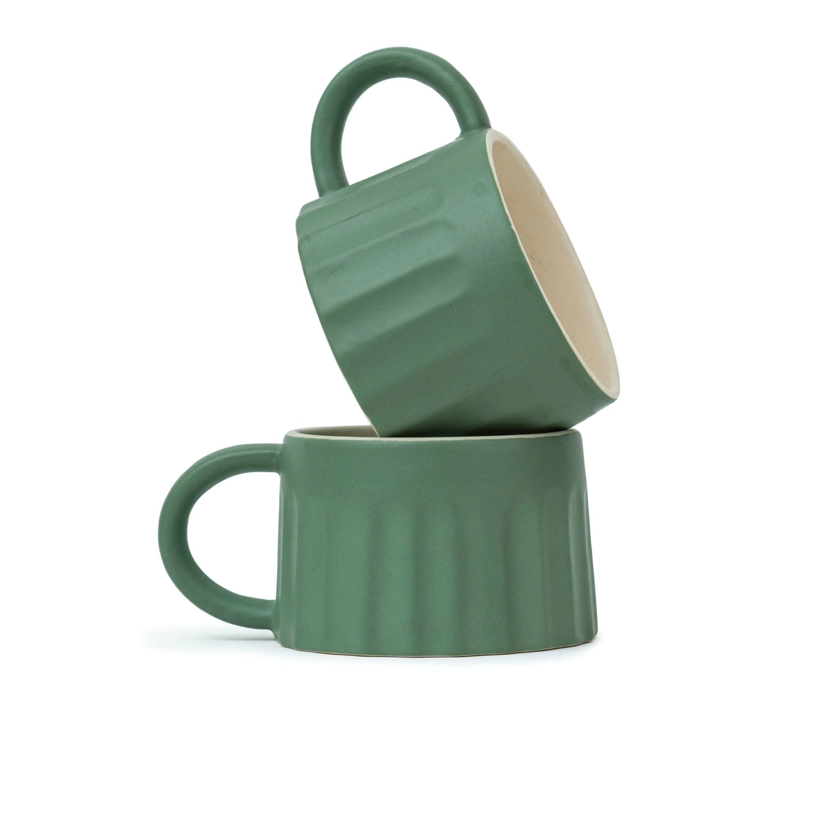 Two green mugs stacked on a white background