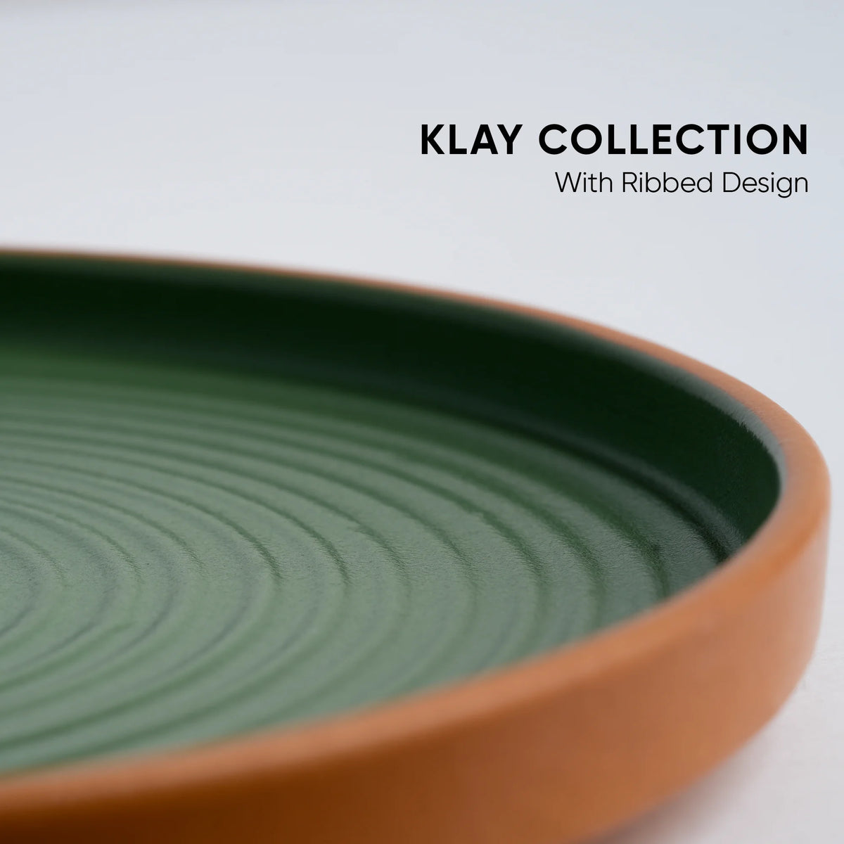 Green ceramic dish with ribbed design on a white background, featuring 'Klay Collection' text.