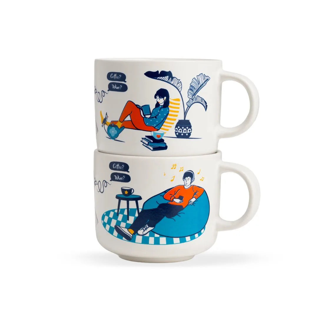 Two stacked mugs with illustrated designs of people sitting and using devices on a white background