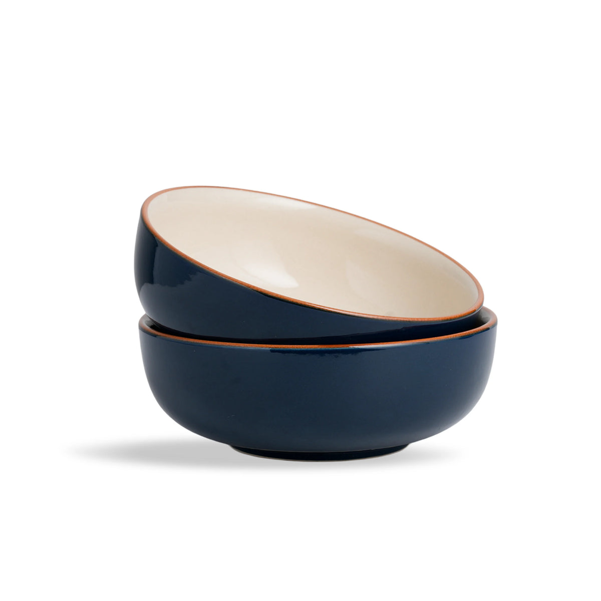 Two navy blue ceramic bowls with beige interior on a white background
