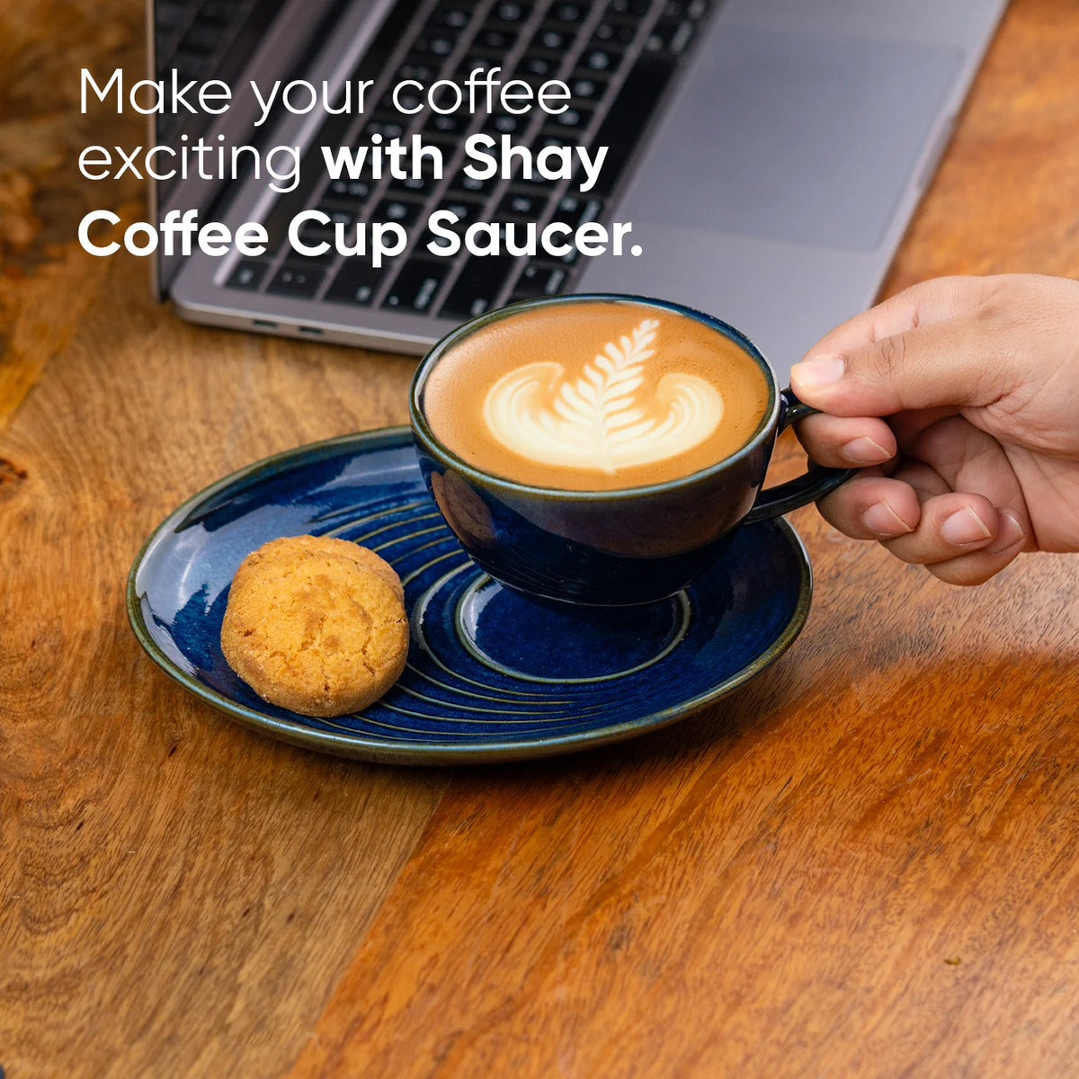 Person holding a coffee cup with latte art on a saucer, with text promoting 'Shay Coffee Cup Saucer'.
