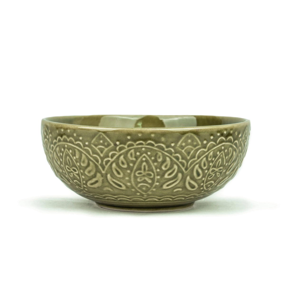 Green ceramic bowl with intricate patterns on a white background