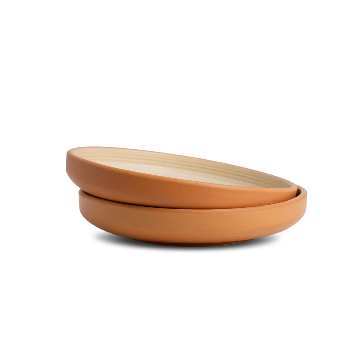 Two terracotta bowls stacked on a white background