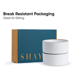 White ceramic jar with gold text next to a teal box with 'SHAY' branding on a white background.