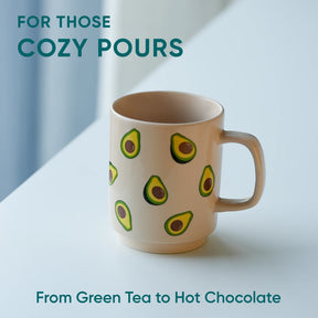 Mug with avocado pattern on a light surface with text about beverages.