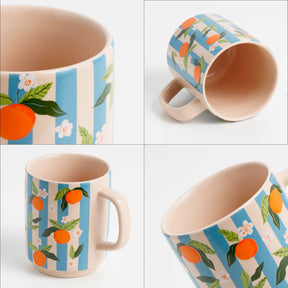 Mug with orange and floral pattern on a white background