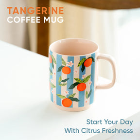 Tangerine-themed coffee mug with decorative design on a white surface.