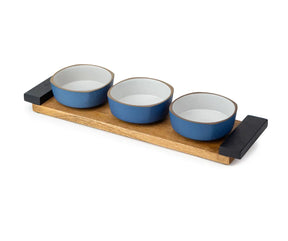 Set of three blue ceramic bowls on a wooden tray with black handles.