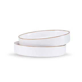 Two white ceramic bowls with gold rims on a white background