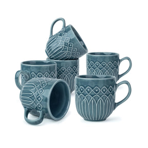 Set of blue ceramic mugs with textured design on a white background