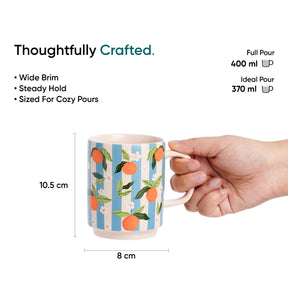 Mug with orange design held by a hand, surrounded by text and measurements on a white background.