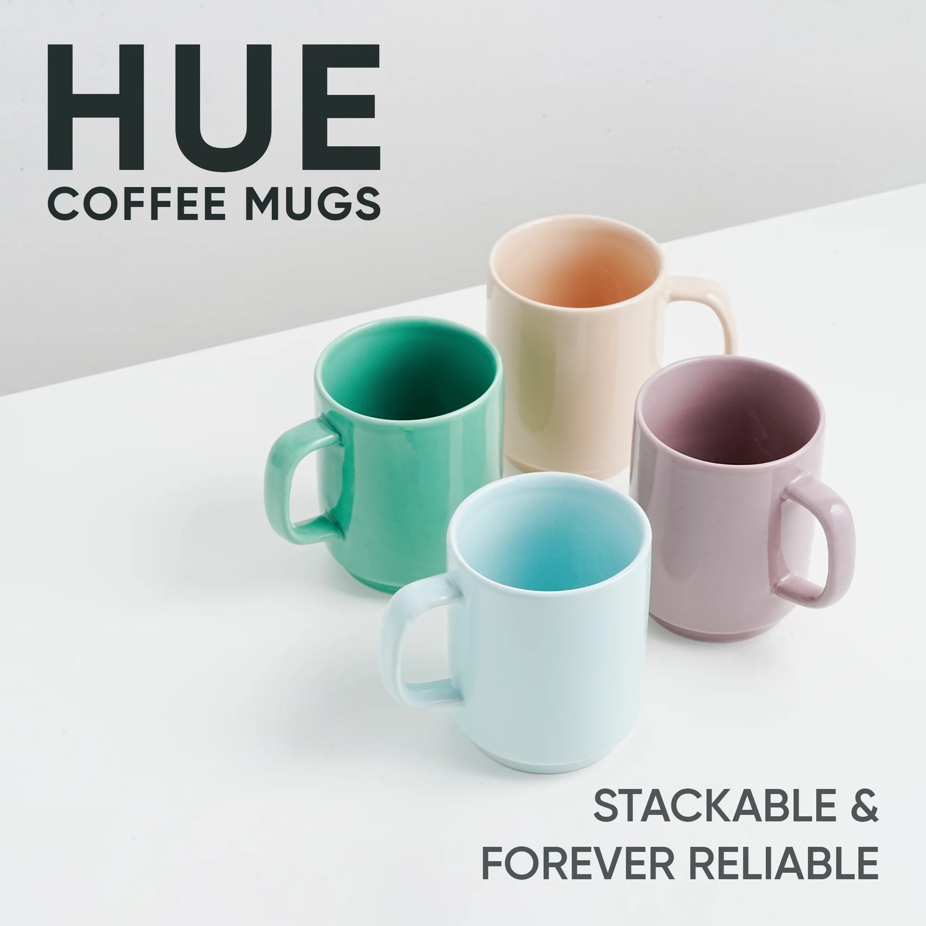 Four colorful coffee mugs on a white surface with 'HUE' branding.