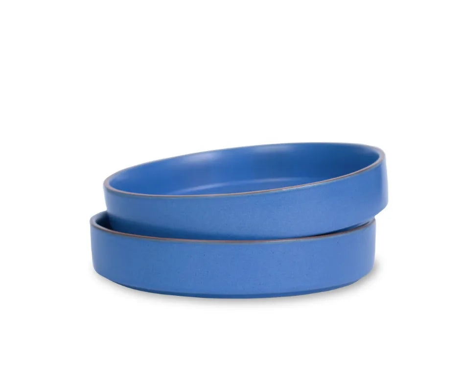 Two blue ceramic bowls on a white background