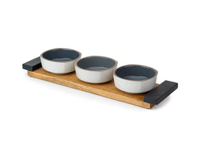 Set of three ceramic bowls with a wooden tray on a white background