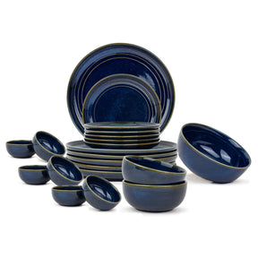 Set of blue ceramic dinnerware on a white background
