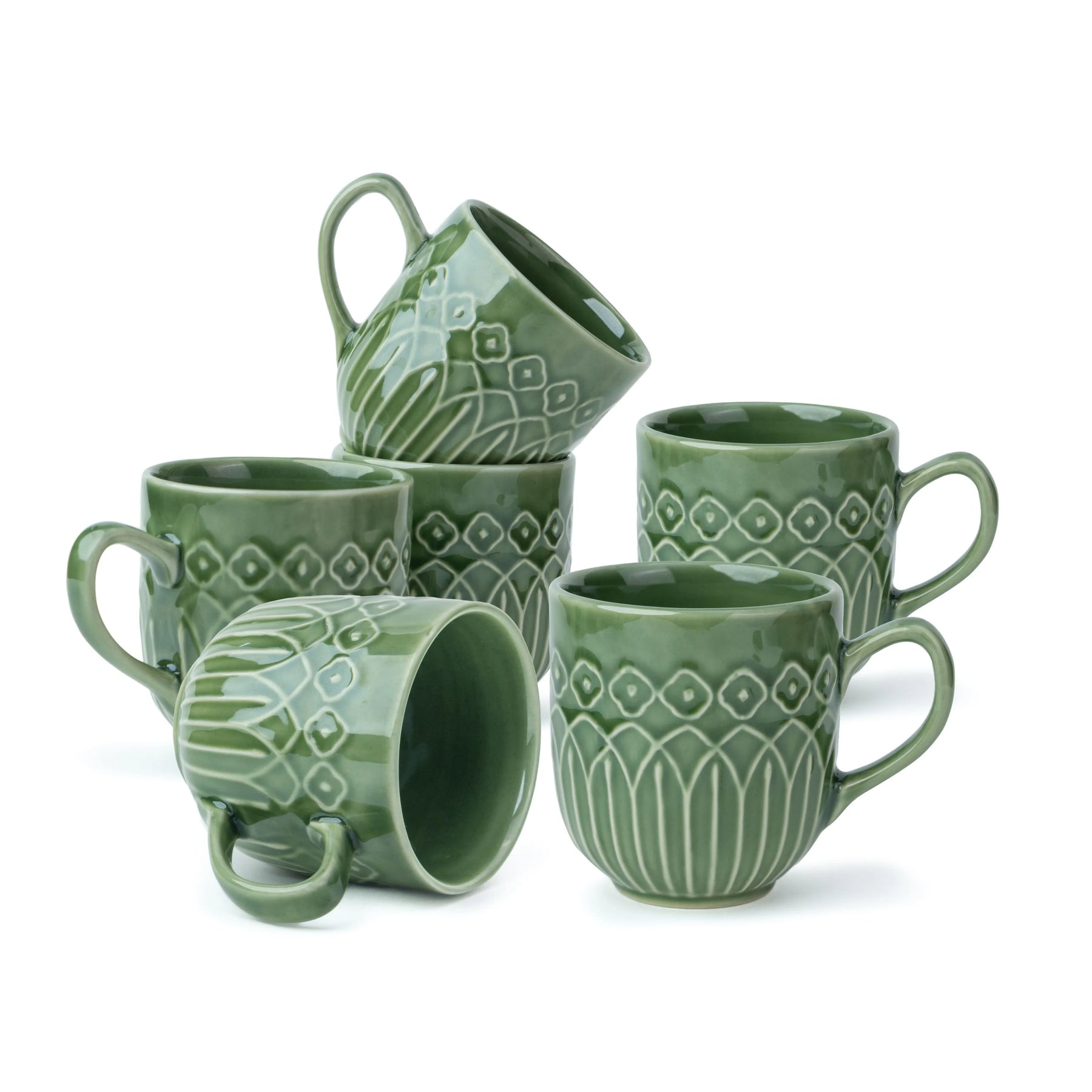 Set of green ceramic mugs with geometric patterns on a white background