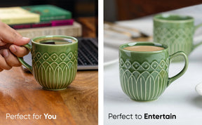 Green ceramic mug with decorative patterns held by a hand and placed on a table.