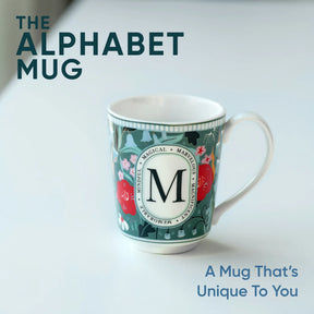 Decorative mug with letter 'M' design on a white background