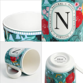 Set of mugs with decorative designs and 'N' branding on a white background