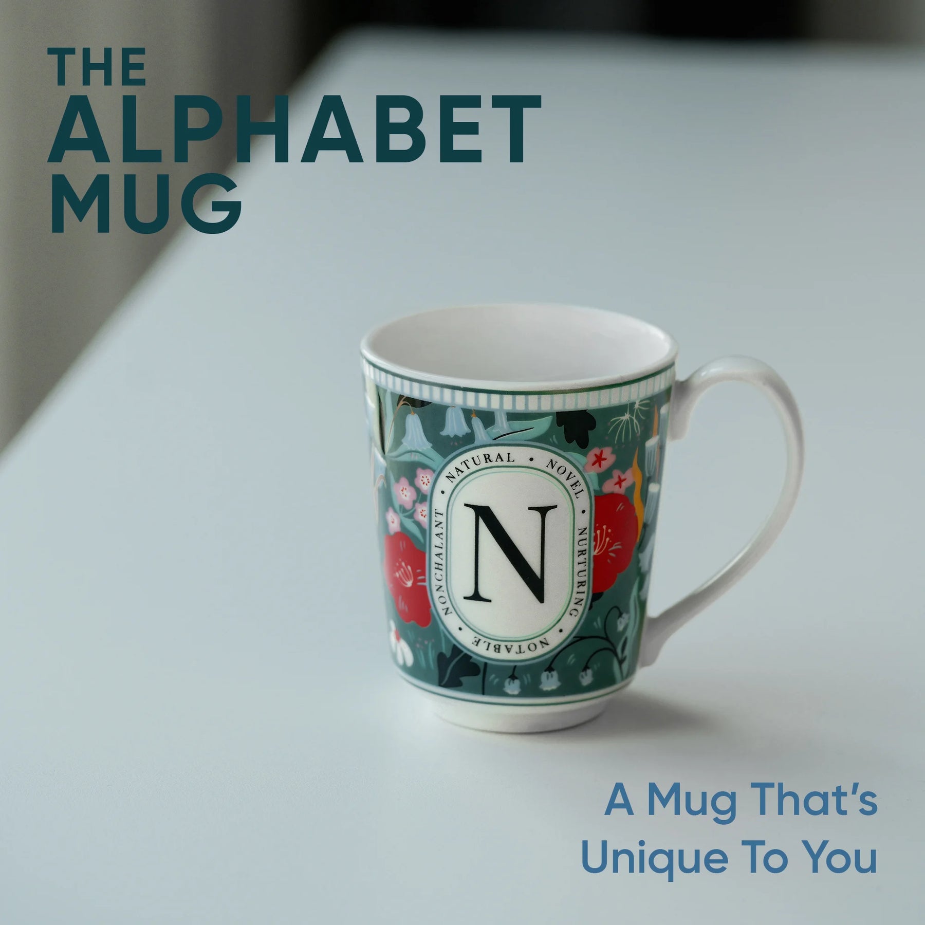 Decorative mug with letter 'N' on a light background, featuring text 'The Alphabet Mug'.