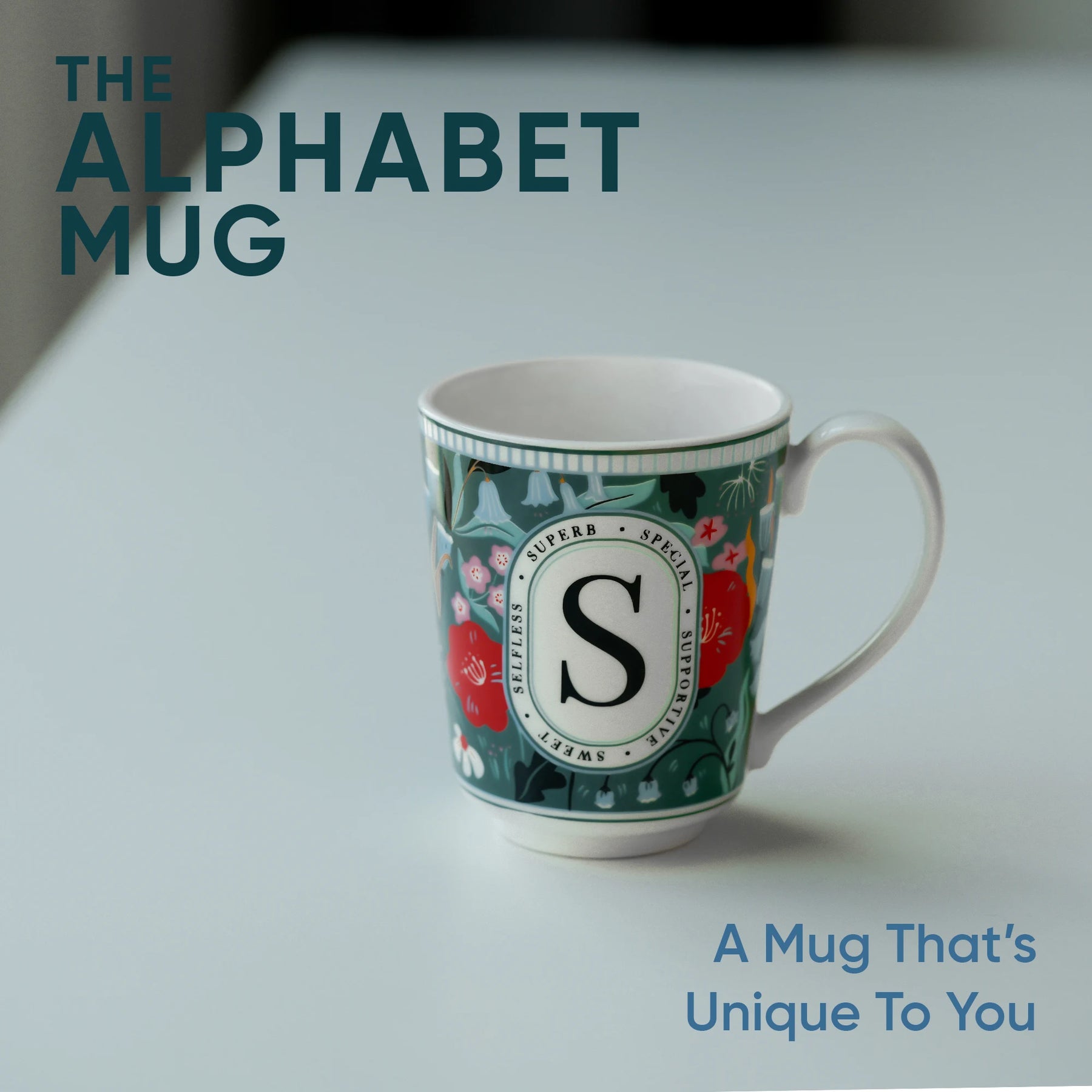 Mug with letter 'S' design on a light background, featuring text 'The Alphabet Mug'.