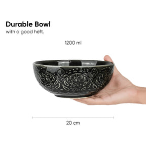 Black decorative bowl held in a hand with text indicating its capacity and dimensions.