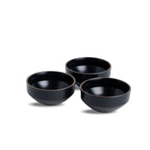 Three black ceramic bowls on a white background