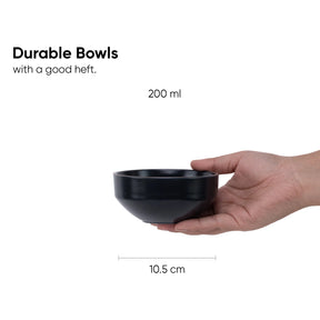 Black bowl held in a hand with text indicating durability and capacity, on a white background.