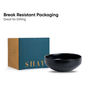 Black bowl in front of a 'SHAY' branded box with text about break-resistant packaging.