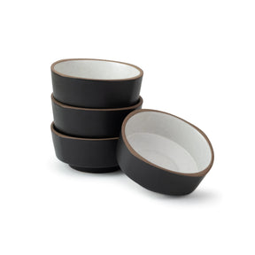 Set of black ceramic bowls with white interior on a white background