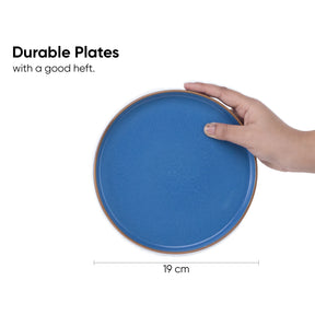 Blue ceramic plate held by a hand with text indicating durability and dimensions.