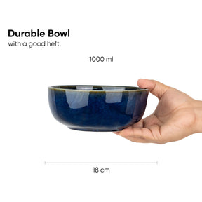 Blue ceramic bowl held by a hand with text indicating its capacity and dimensions.