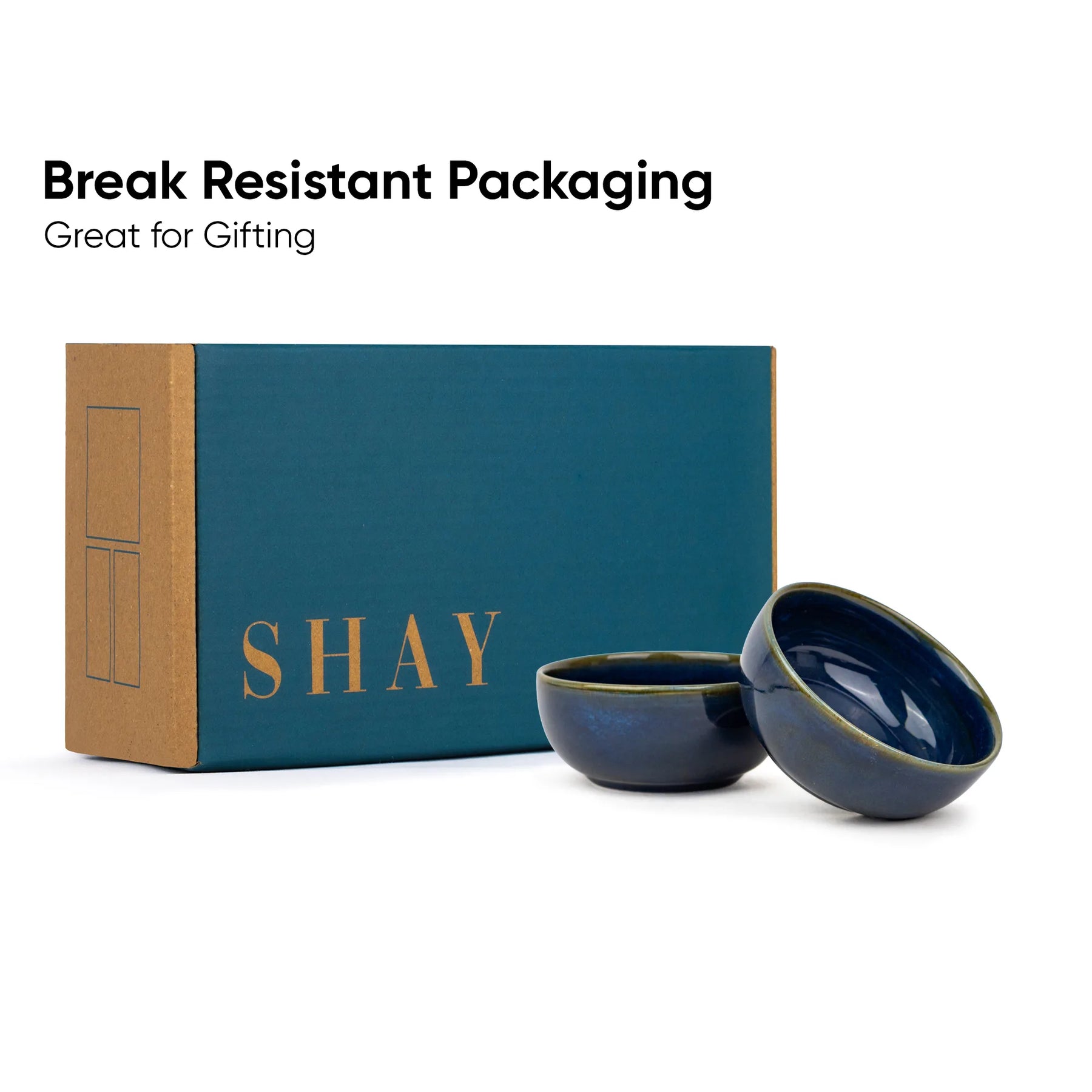 Two blue ceramic bowls in front of a teal box with 'SHAY' branding on a white background.