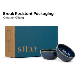 Two blue ceramic bowls in front of a teal box with 'SHAY' branding on a white background.