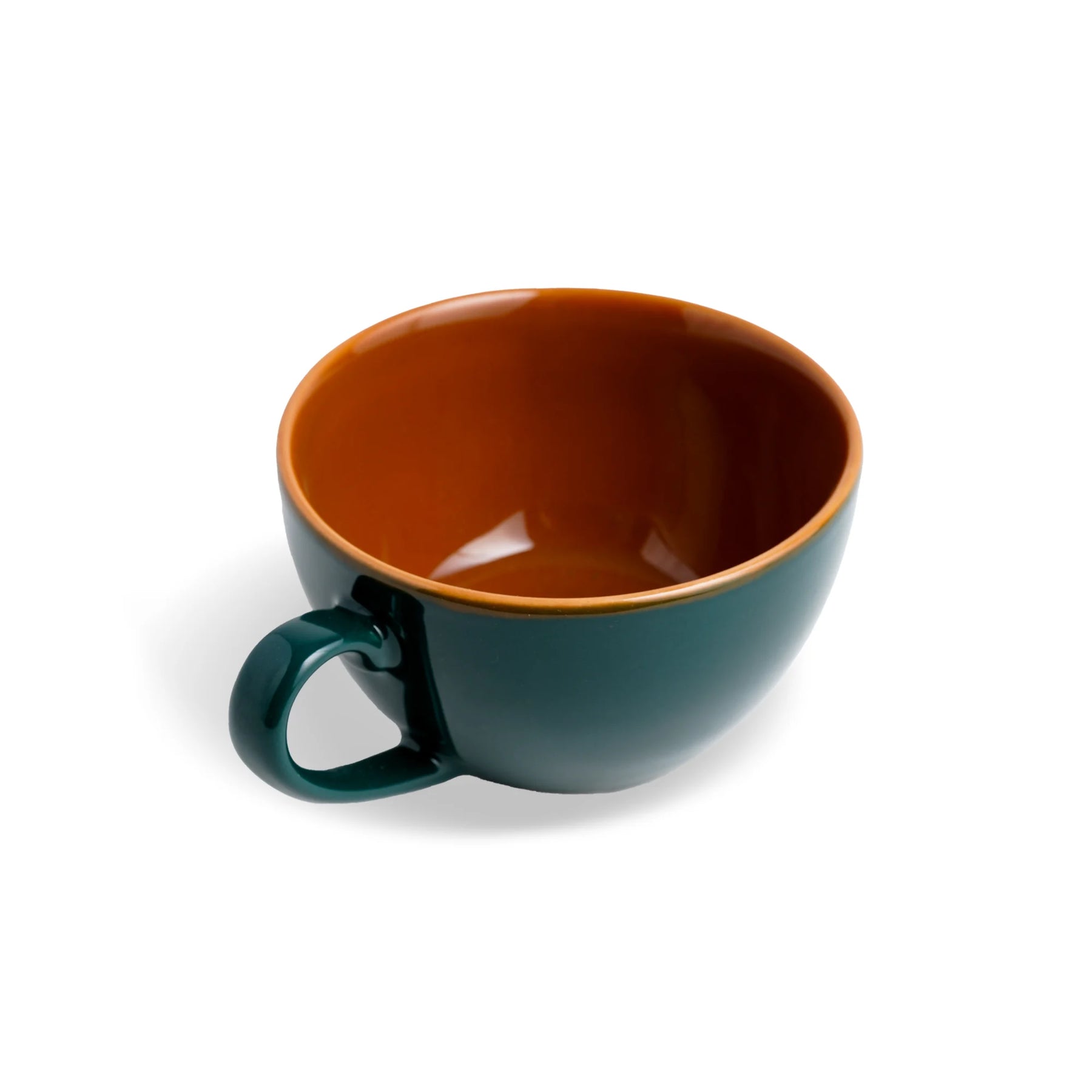 Green mug with a brown interior on a white background
