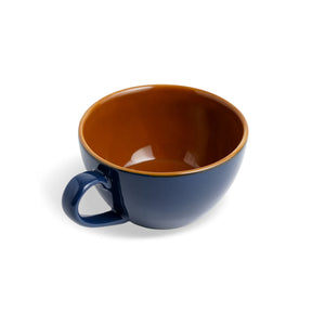Blue mug with a brown interior on a white background