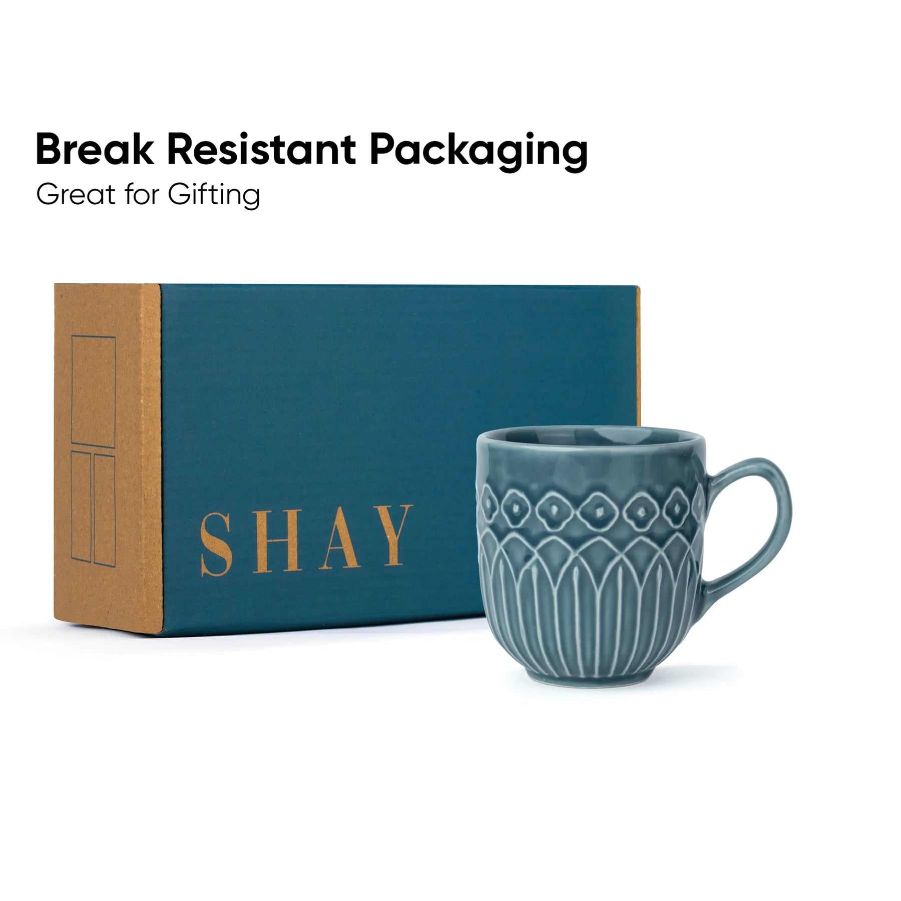 Blue mug with decorative patterns next to a blue box labeled 'SHAY' on a white background.