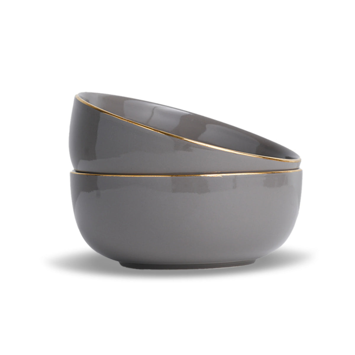 Two gray ceramic bowls with gold rims stacked on a white background