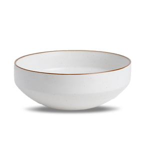 White ceramic bowl with a gold rim on a white background