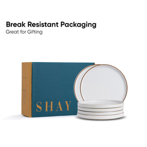 Set of white plates with gold rim in 'SHAY' branded packaging on a white background