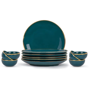 Set of teal ceramic plates and bowls with gold rims on a white background