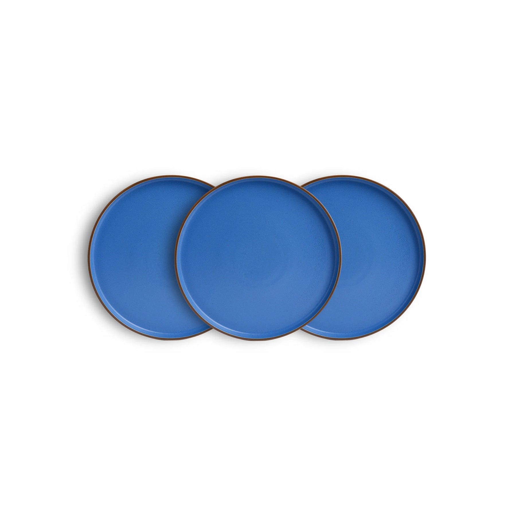 Three blue ceramic plates with gold rims on a white background
