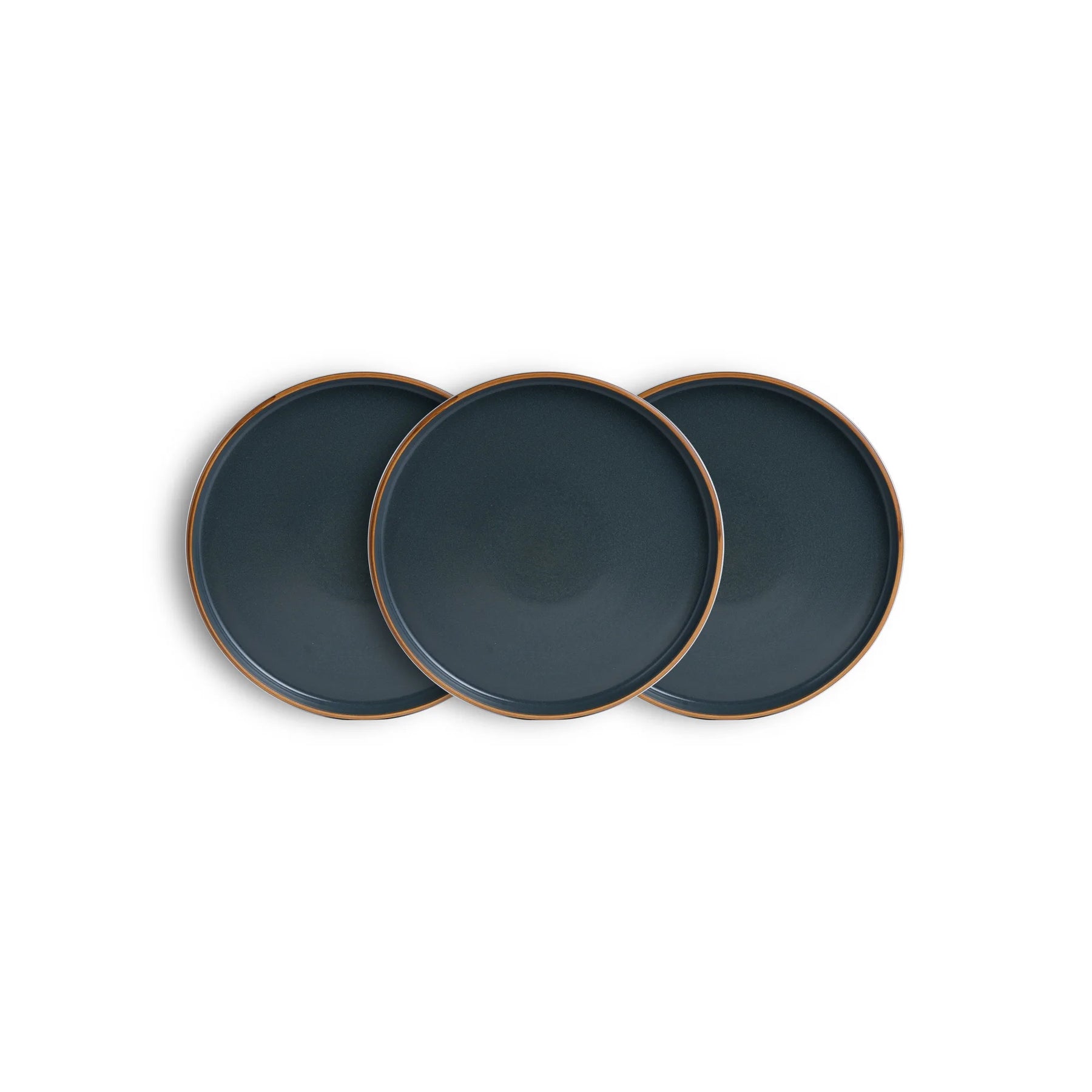 Three dark blue plates with bronze rims on a white background
