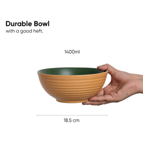 Hand holding a durable bowl with measurements on a white background