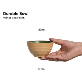 Hand holding a durable bowl with measurement details on a white background