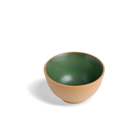 Green and brown ceramic bowl on a white background